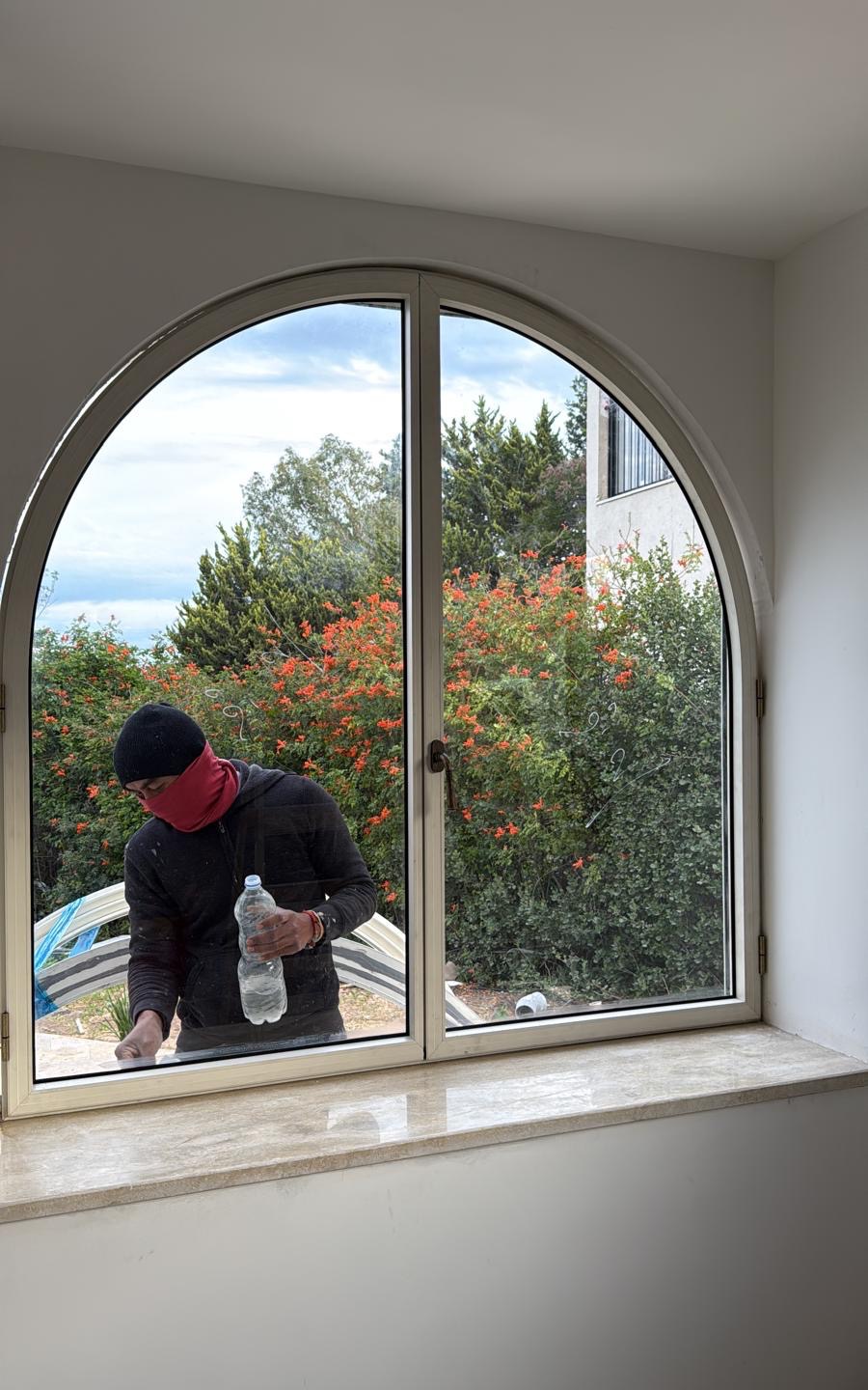 Custom arched window on installation day